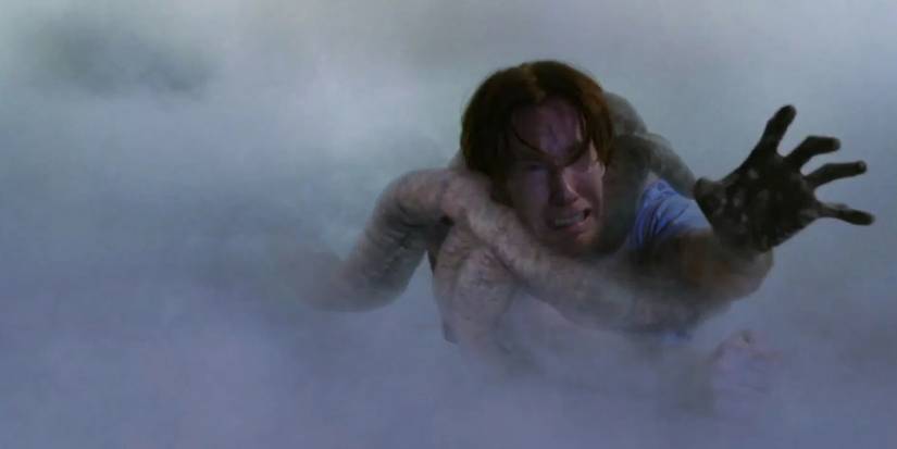 A store employee being pulled away by a monster in The Mist