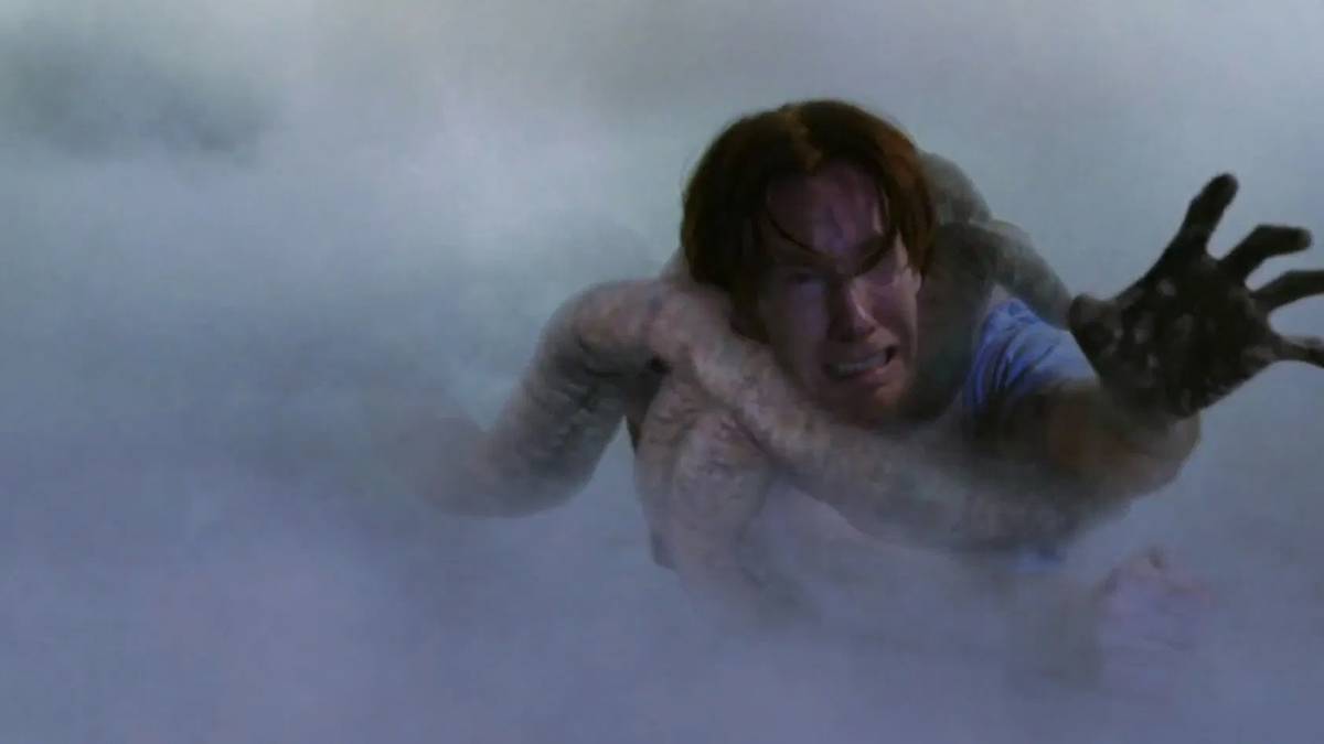 A store employee being pulled away by a monster in The Mist