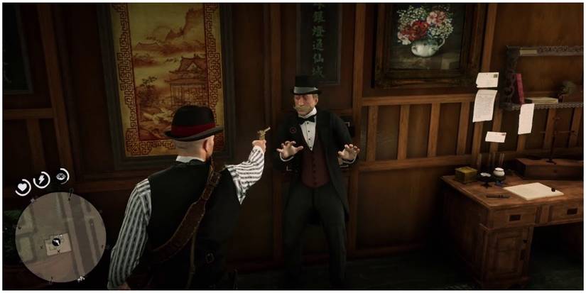 Arthur holding a man at gunpoint