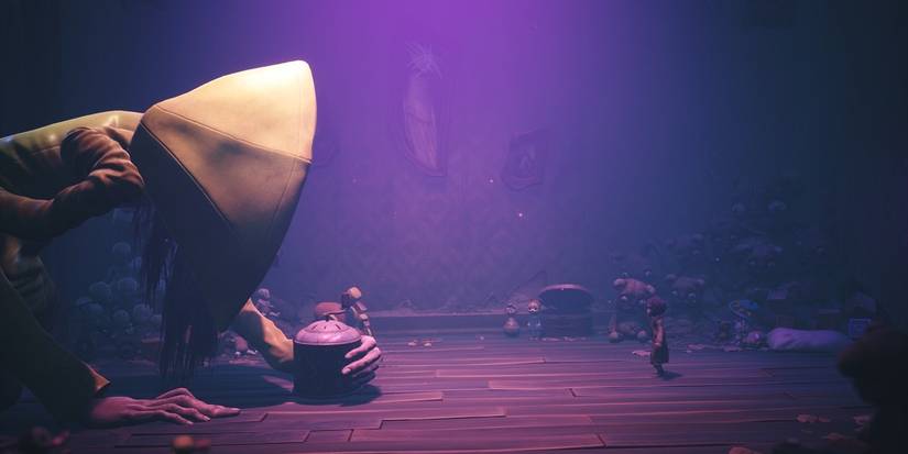 A monsterous Six clutches her music box in front of Mono