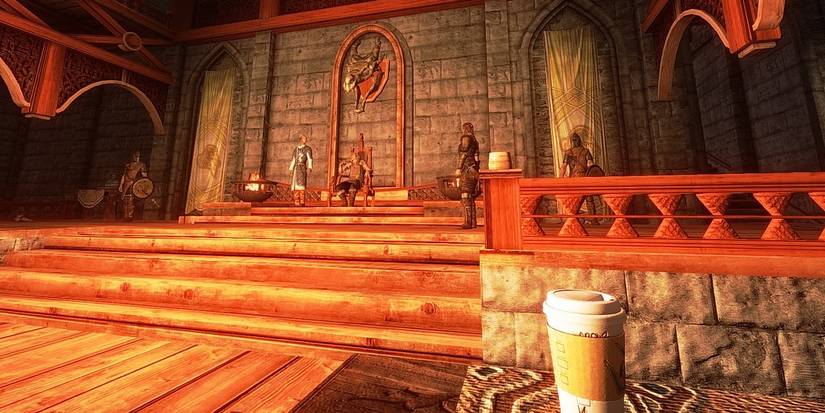 A coffee cup sits on a table in the Jarl's hall, Skyrim