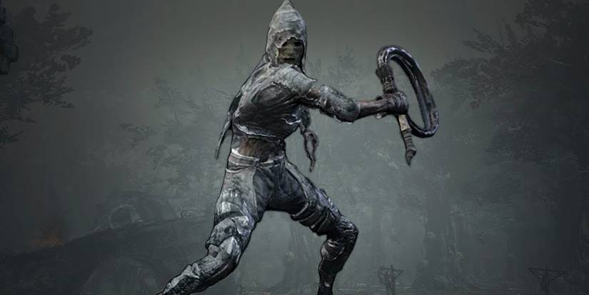 player posing with spotted whip in front of a grey background.