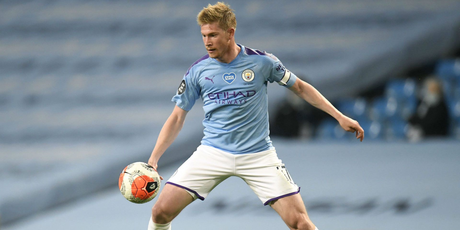 professional player Kevin De Bruyne with soccer ball