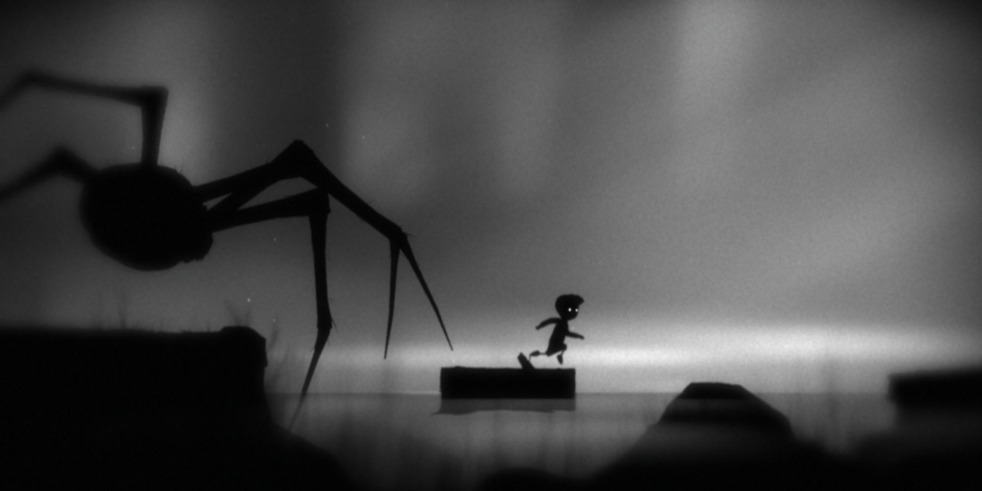 Limbo gameplay screenshot of boy running from spider