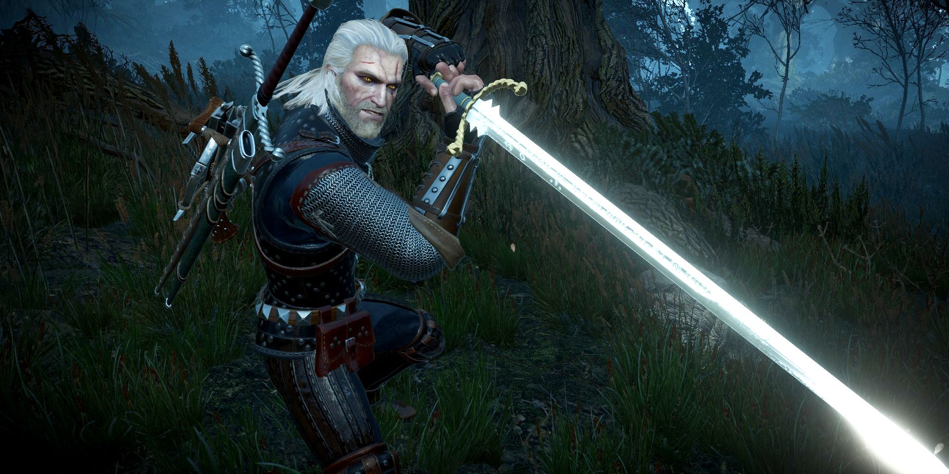 geralt holding a silver sword in battle stance.