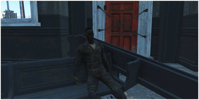 A raider's corpse near the chained doors at the church