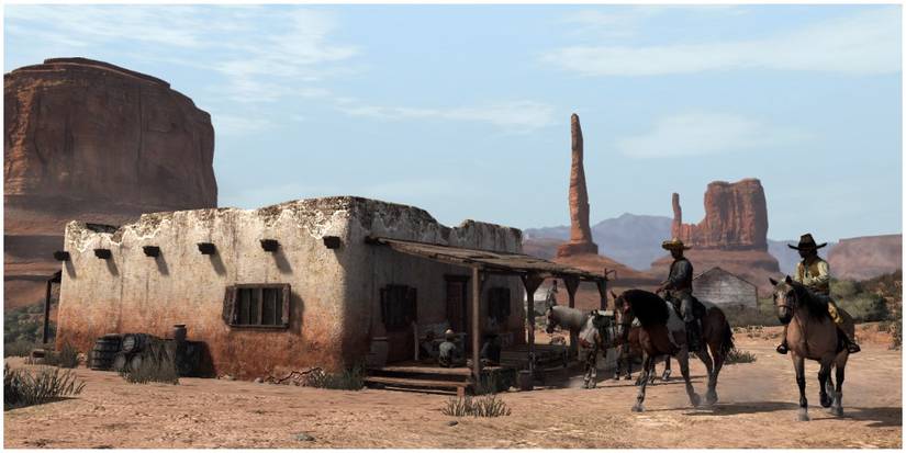 Horseback riders riding through the town of El Matadero