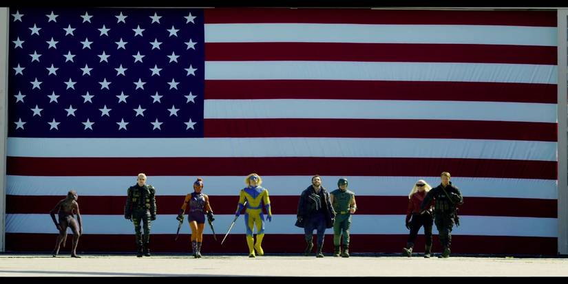 Entire Suicide Squad Walking With American Flag Behind Them