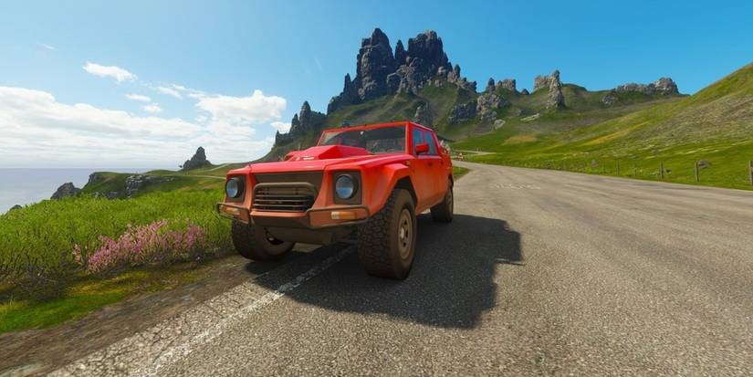 Forza Horizon 4 Lamborghini LM 002 driving on curb of road with moutain in the background