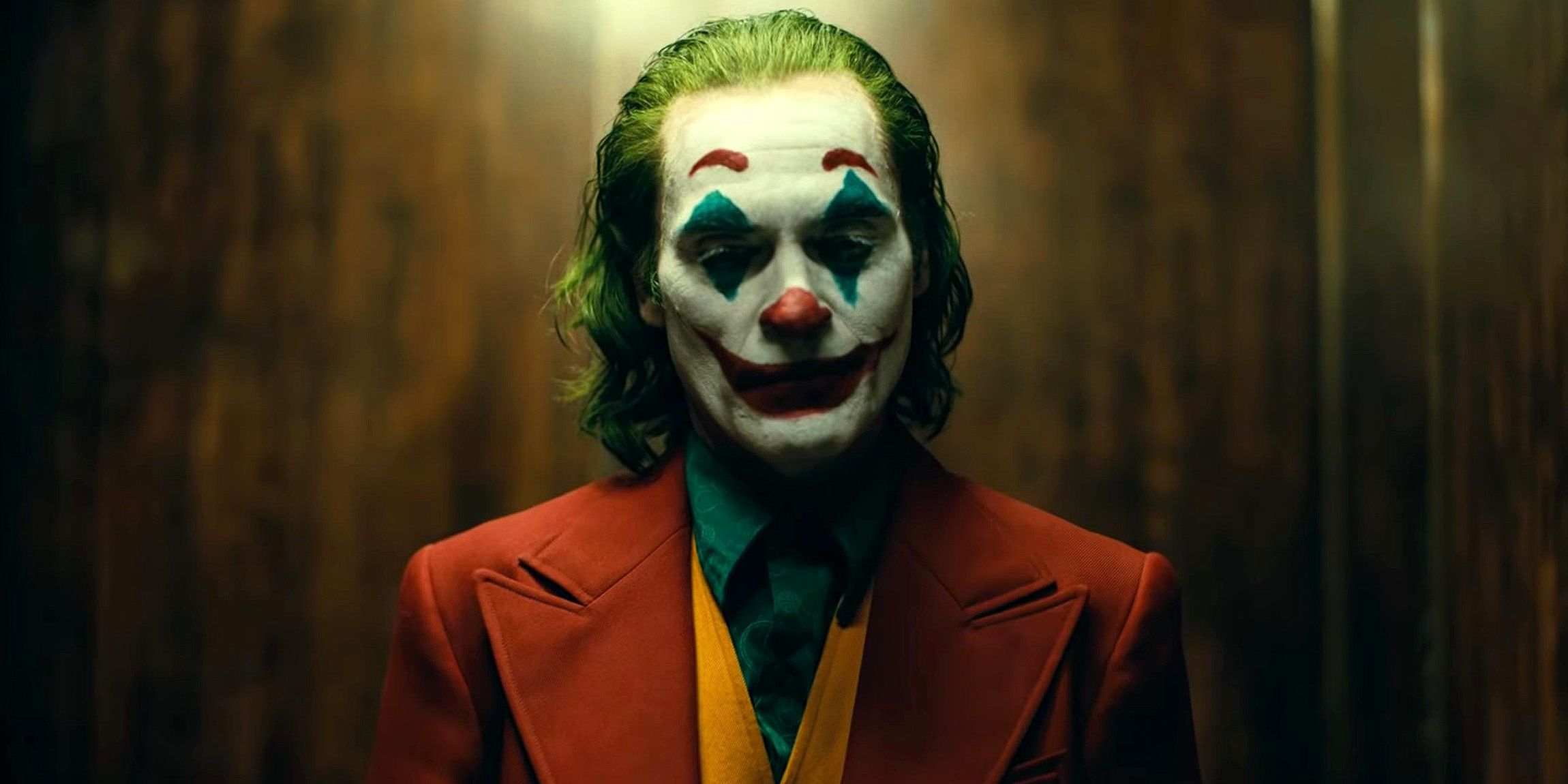 Joaquin Phoenix as Arthur Fleck leaving the elevator in Joker