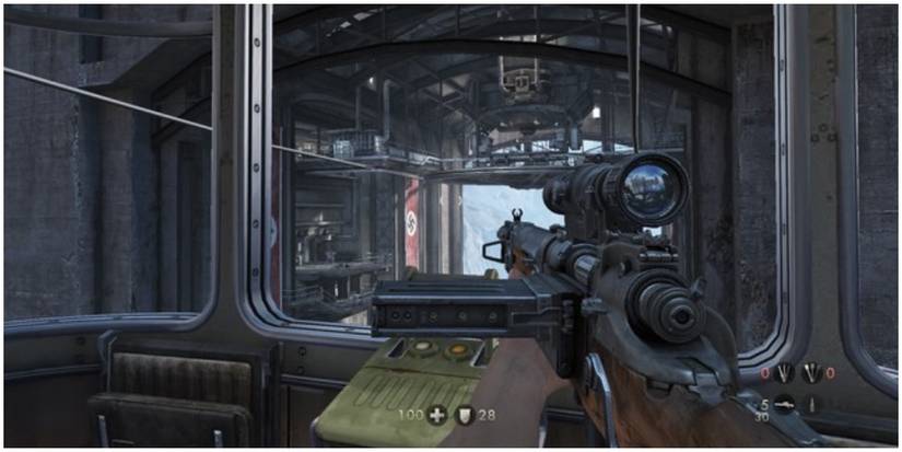 A player hiding behind cover attacking an enemy