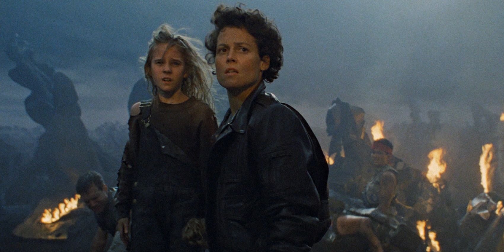 Ripley and Newt standing in the wreckage of the ship in Aliens