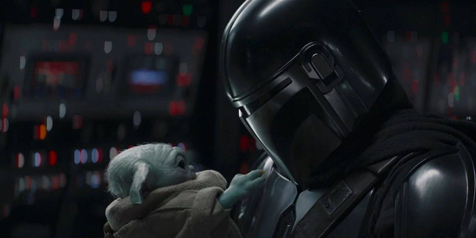 The Mandalorian holding Grogu on the Razor Crest