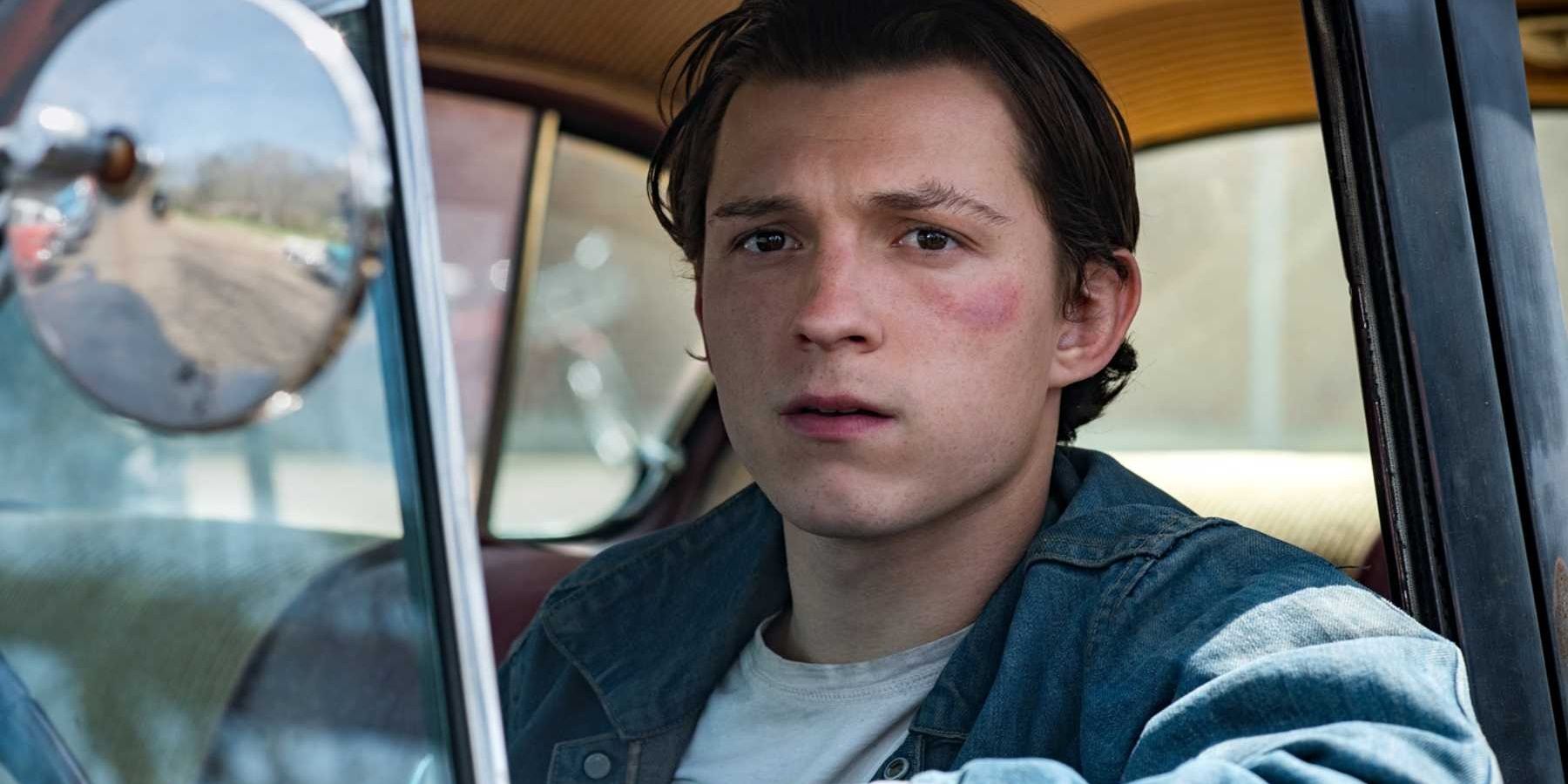 Tom Holland sitting in a car in The Devil All the Time