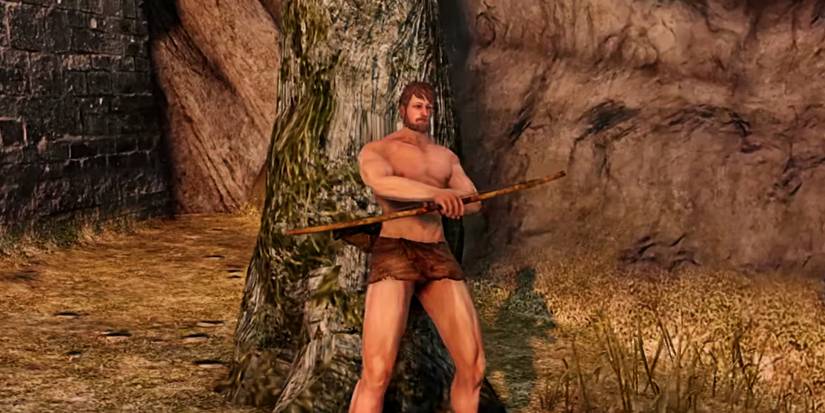 player holding a short wooden bow.