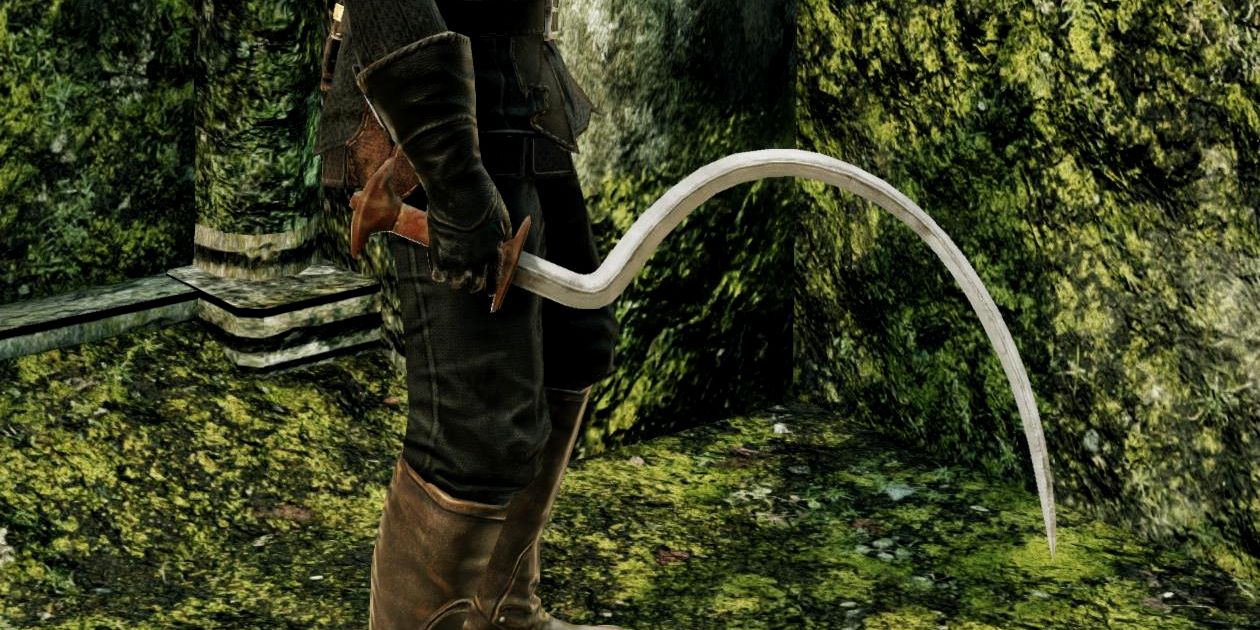 close up of player holding an extremely curved sword.