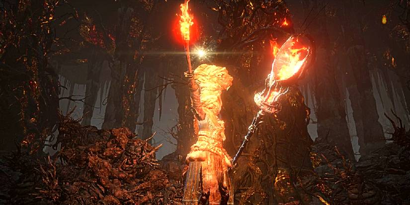 player holding up a torch and a fiery hammer.