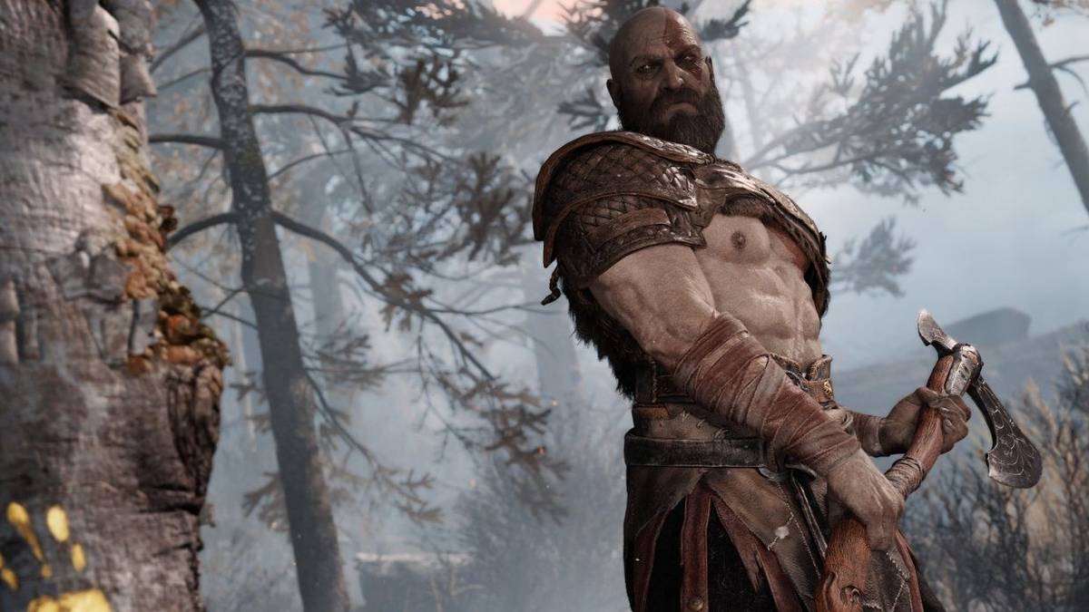 god of war kratos looks at tree axe in hand