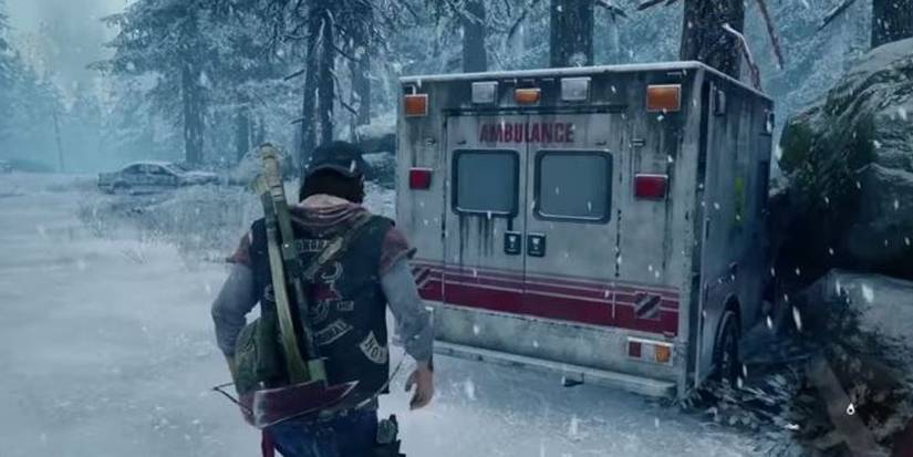 Man approaching ambulance in snow.