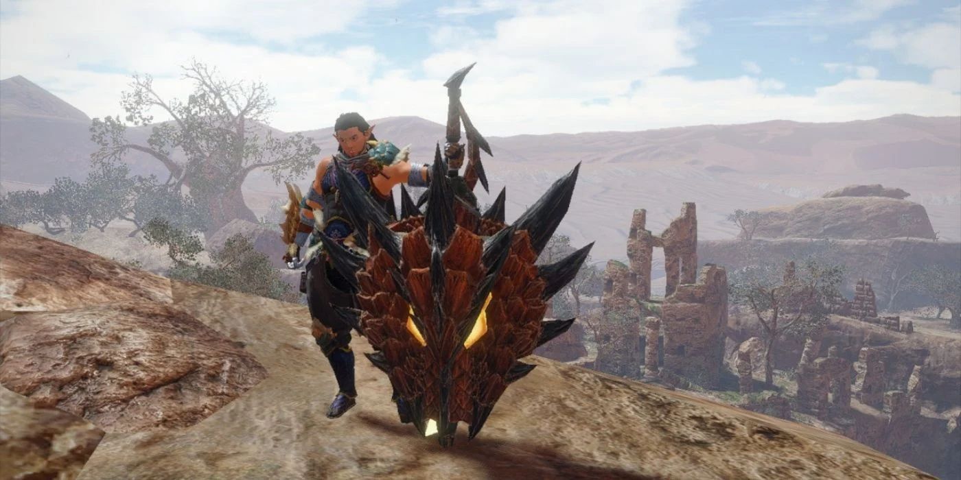 A Hunter Wielding A Charge Blade Stands Atop A Mountain
