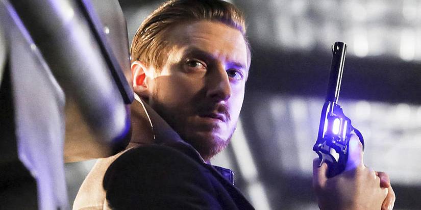 Legends of Tomorrow Rip Hunter holds a gun