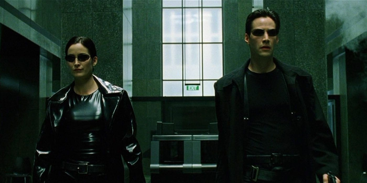 Neo and Trinity in The Matrix in black leather wealking through building lobby