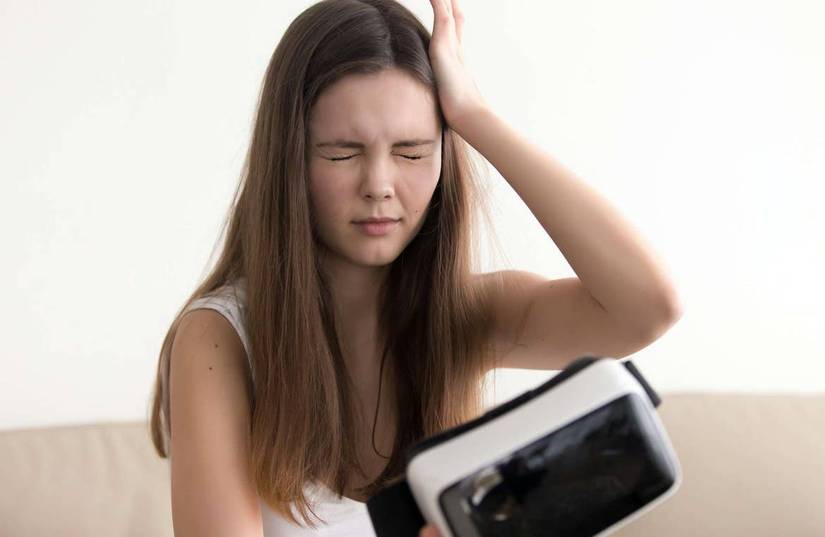 Woman with VR headset and headache