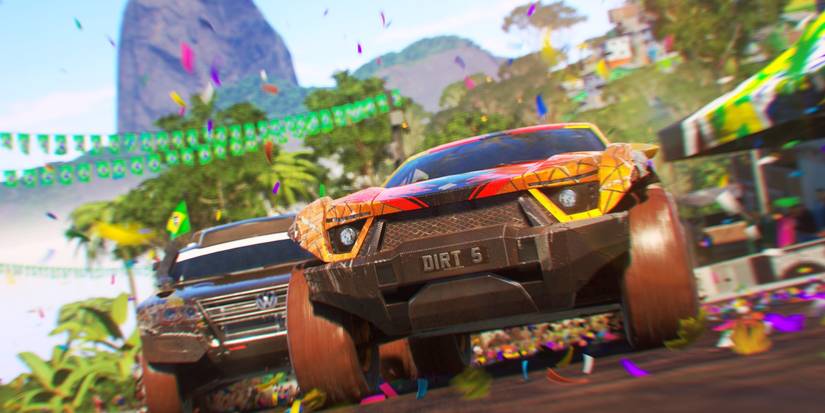 cars racing with a mountain in the background