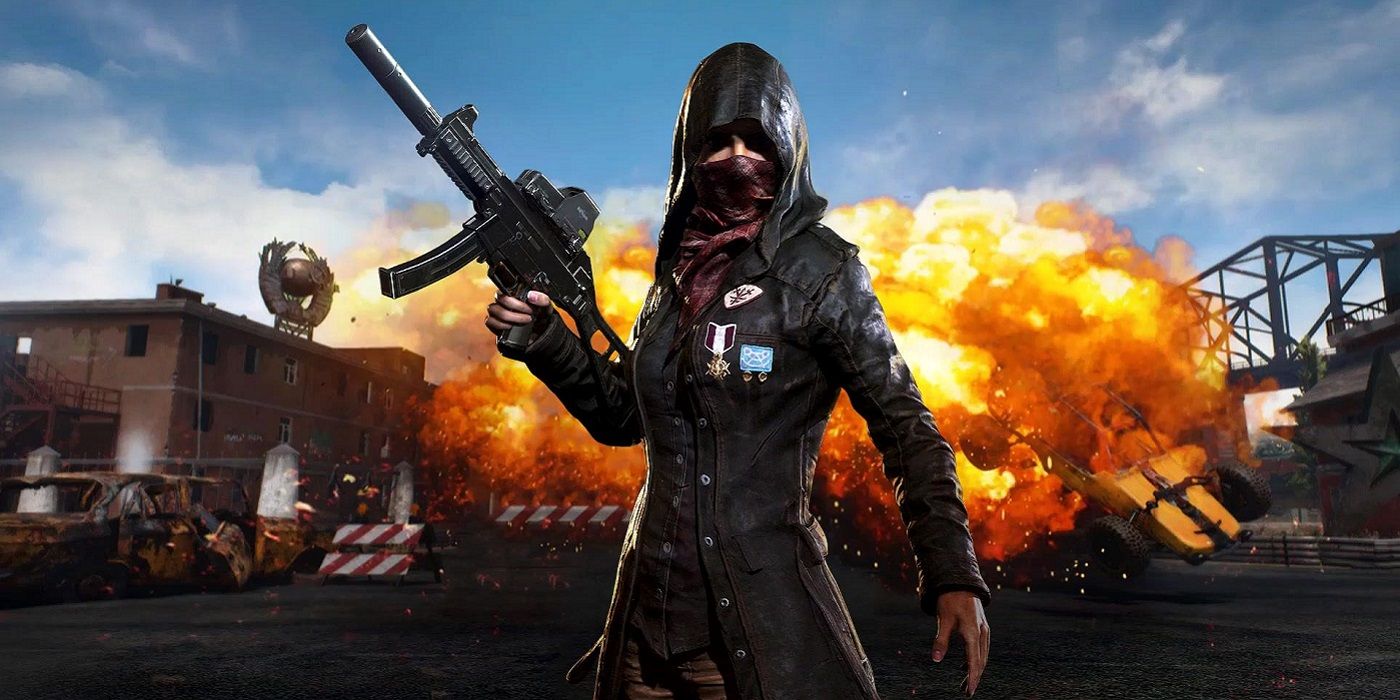 PUBG screenshot showing female character in the foreground as something explodes behind her.