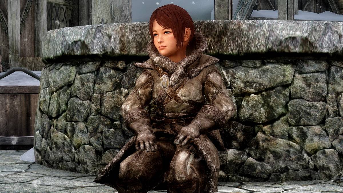 Skyrim screenshot showing a child kneeling down in front of a well.