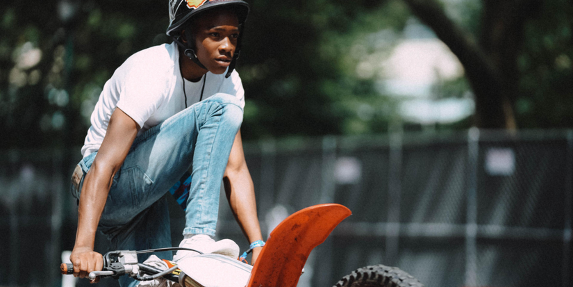 Mouse rides a dirt bike in Charm City Kings