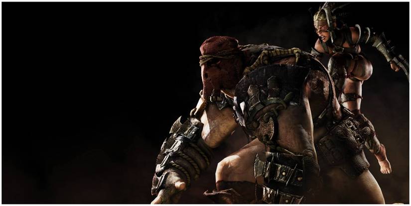 A smaller girl riding on a massive man's back