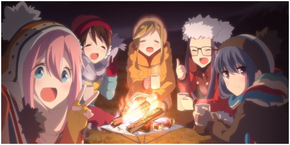 Girls surrounding a campfire