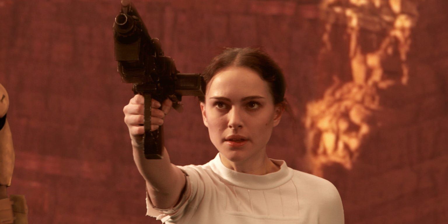 Natalie Portman as Padme Amidala holding a blaster in Attack of the Clones