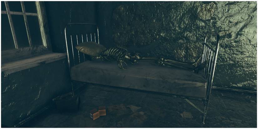 A skeleton with a pillow over its face