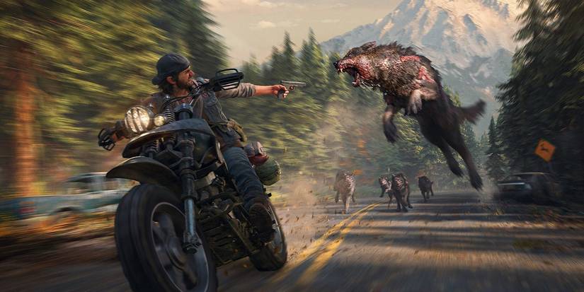 Action shot from Days Gone showing Deacon riding a motorcycle while shooting a wolf behind him.