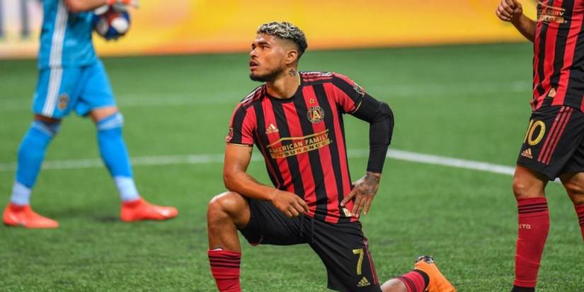 Josef Martinez Kneeling