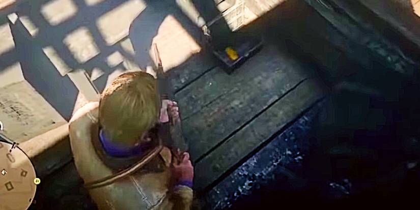 arthur morgan about to loot a gold bar.