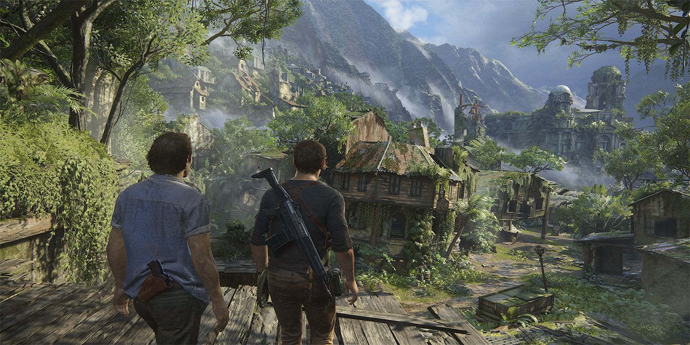 Nathan Drake stands with his brother Sam overlooking a dilapidated village