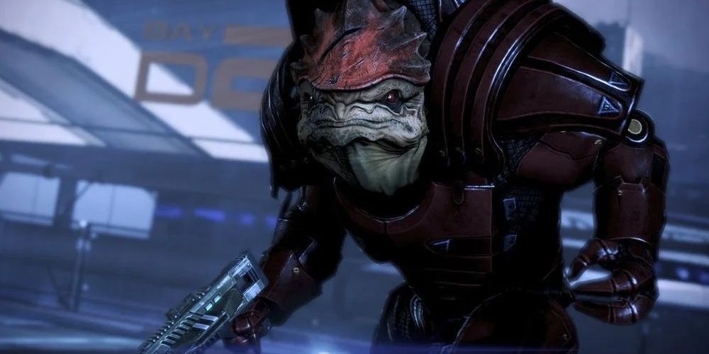 A very angry Wrex stands at the citadel with his weapon drawn in Mass Effect 3