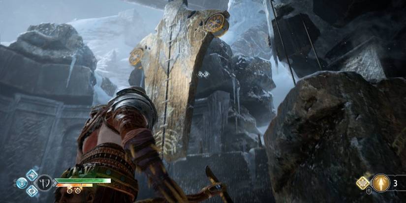 Kratos in front of the giant pendant at Thamurs corpse in God of War