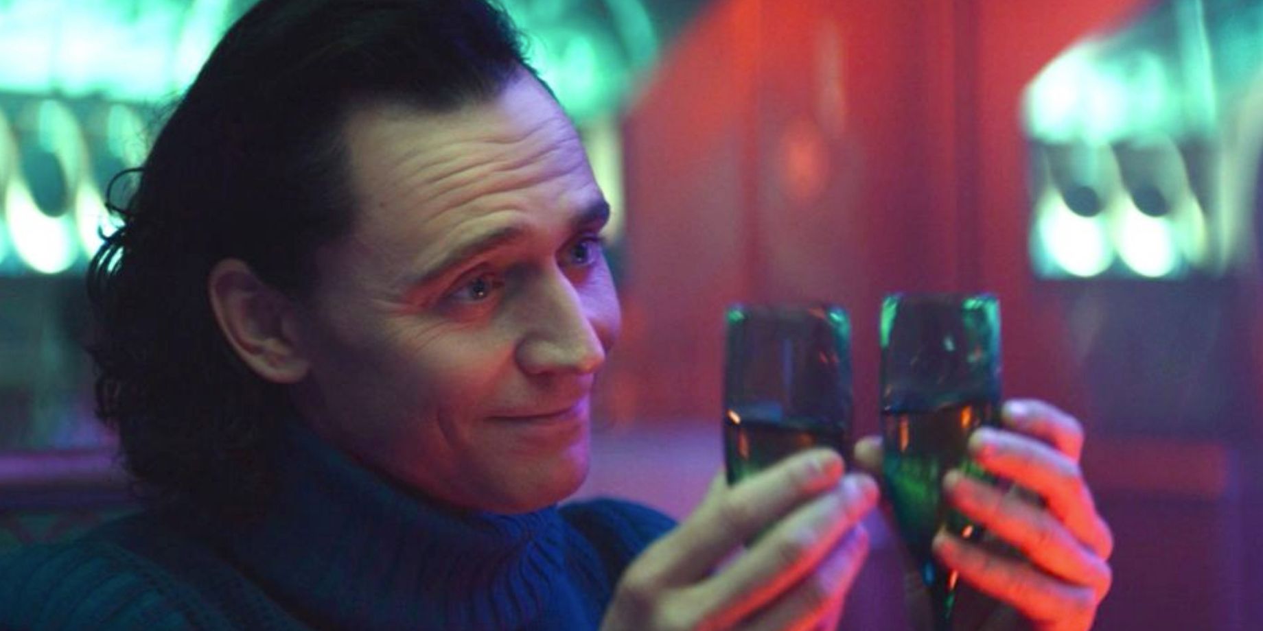 Loki holds two champagne glasses in Loki episode 3