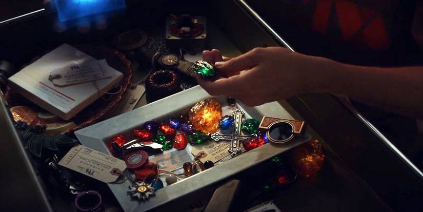 Loki looks through a drawer full of Infinity Stones