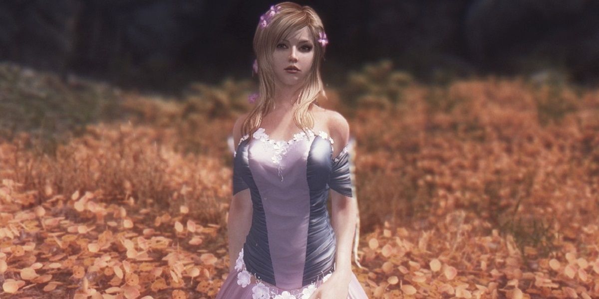 Mod follower Mirai by Kaleidx wearing her wedding dress and standing in a Skyrim field
