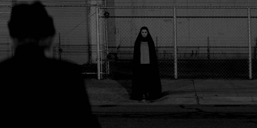 The Girl standing on the street in A Girl Walks Home Alone at Night