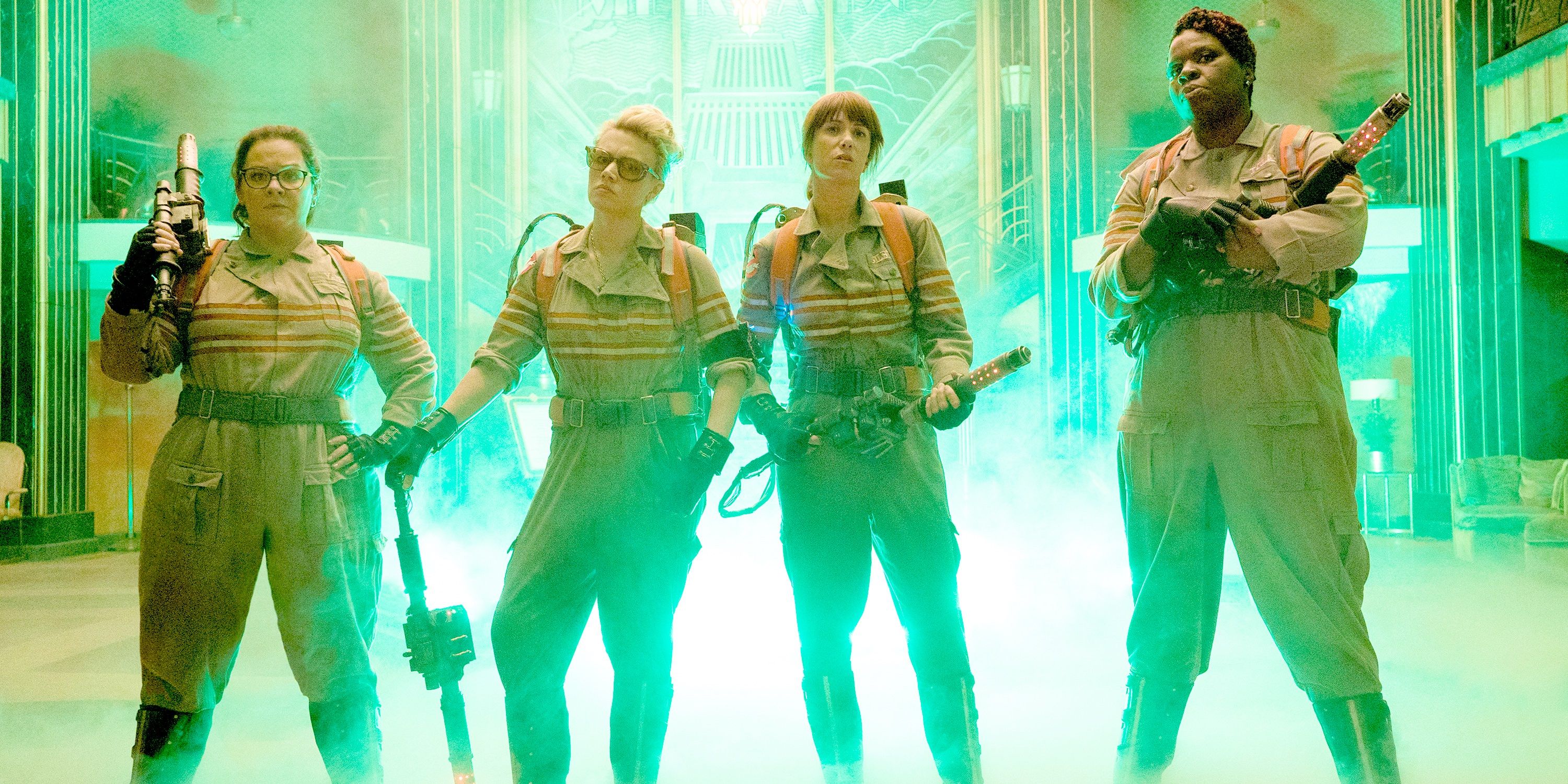 The cast of the 2016 Ghostbusters reboot surrounded by green smoke