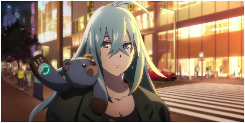 A woman with a strange teddy bear on her shoulder.