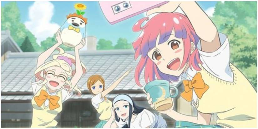 A group of girls taking a selfie with pottery they made.