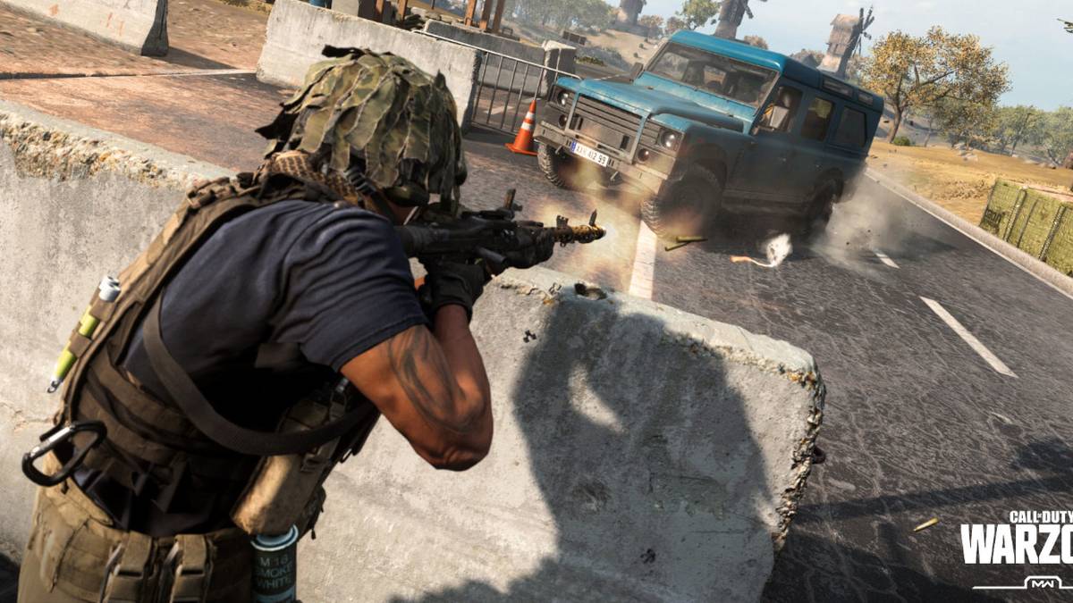call-of-duty-warzone-man-shooting-from-behind-concrete-barrier