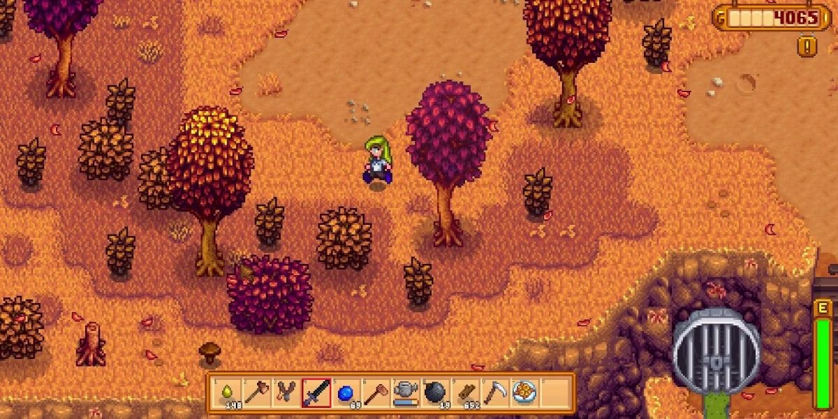 Stardew Valley Character among fall trees and bushes.